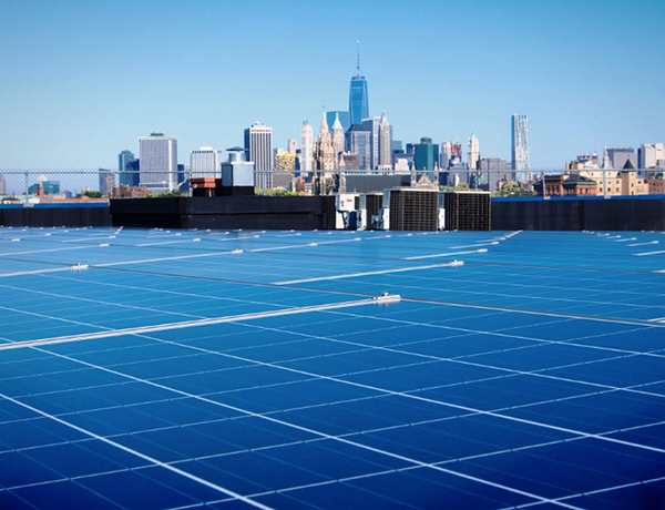Close up of solar panels with a view of New York City skyline